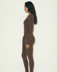 Romy Knit Pants in chocolate brown, featuring a high-waisted fit, soft knit fabric, and a front-tie detail for a stylish and comfortable look. Perfect for casual or elevated cozy outfits
Romy Knit Top styled in a minimalist setting. Featuring a sleek, fitted design with a boat neckline and ribbed texture, it exudes contemporary elegance. Soft lighting and neutral tones enhance its sophisticated appeal."