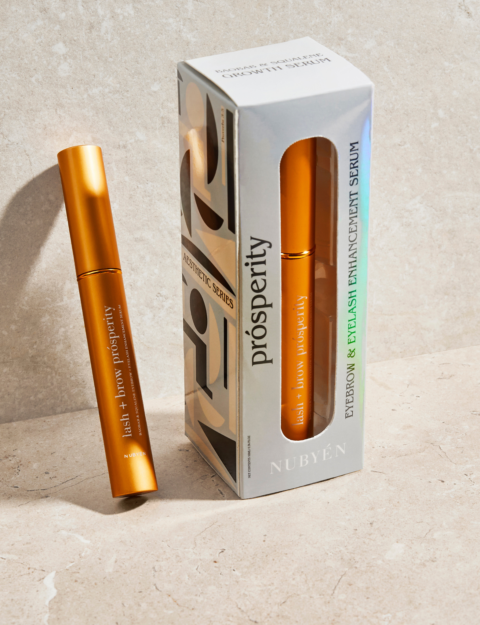 Rejuvenate and strengthen lashes and brows with Nubyén Lash + Brow Prosperity Growth Enhancer. This 100% natural serum combines Baobab, Olive Squalene, Tamanu, and Candlenut oils to repair and nourish hair follicles. Infused with rosemary and raspberry seed extracts, it rebuilds keratin bonds for fuller, thicker brows and lashes. Lightweight, fast-absorbing, and free from harsh chemicals, it's the perfect solution for safe and natural lash and brow enhancement. Pair with Restore Me Brow Pomade for ultimate
