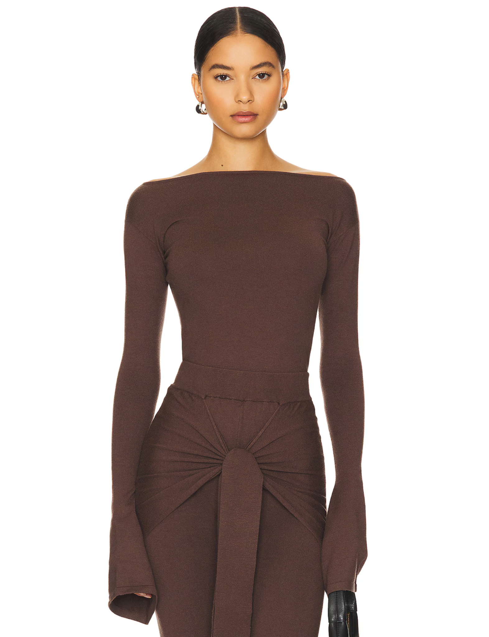 Romy Knit Pants in chocolate brown, featuring a high-waisted fit, soft knit fabric, and a front-tie detail for a stylish and comfortable look. Perfect for casual or elevated cozy outfits
Romy Knit Top styled in a minimalist setting. Featuring a sleek, fitted design with a boat neckline and ribbed texture, it exudes contemporary elegance. Soft lighting and neutral tones enhance its sophisticated appeal."