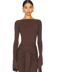 Romy Knit Pants in chocolate brown, featuring a high-waisted fit, soft knit fabric, and a front-tie detail for a stylish and comfortable look. Perfect for casual or elevated cozy outfits
Romy Knit Top styled in a minimalist setting. Featuring a sleek, fitted design with a boat neckline and ribbed texture, it exudes contemporary elegance. Soft lighting and neutral tones enhance its sophisticated appeal."