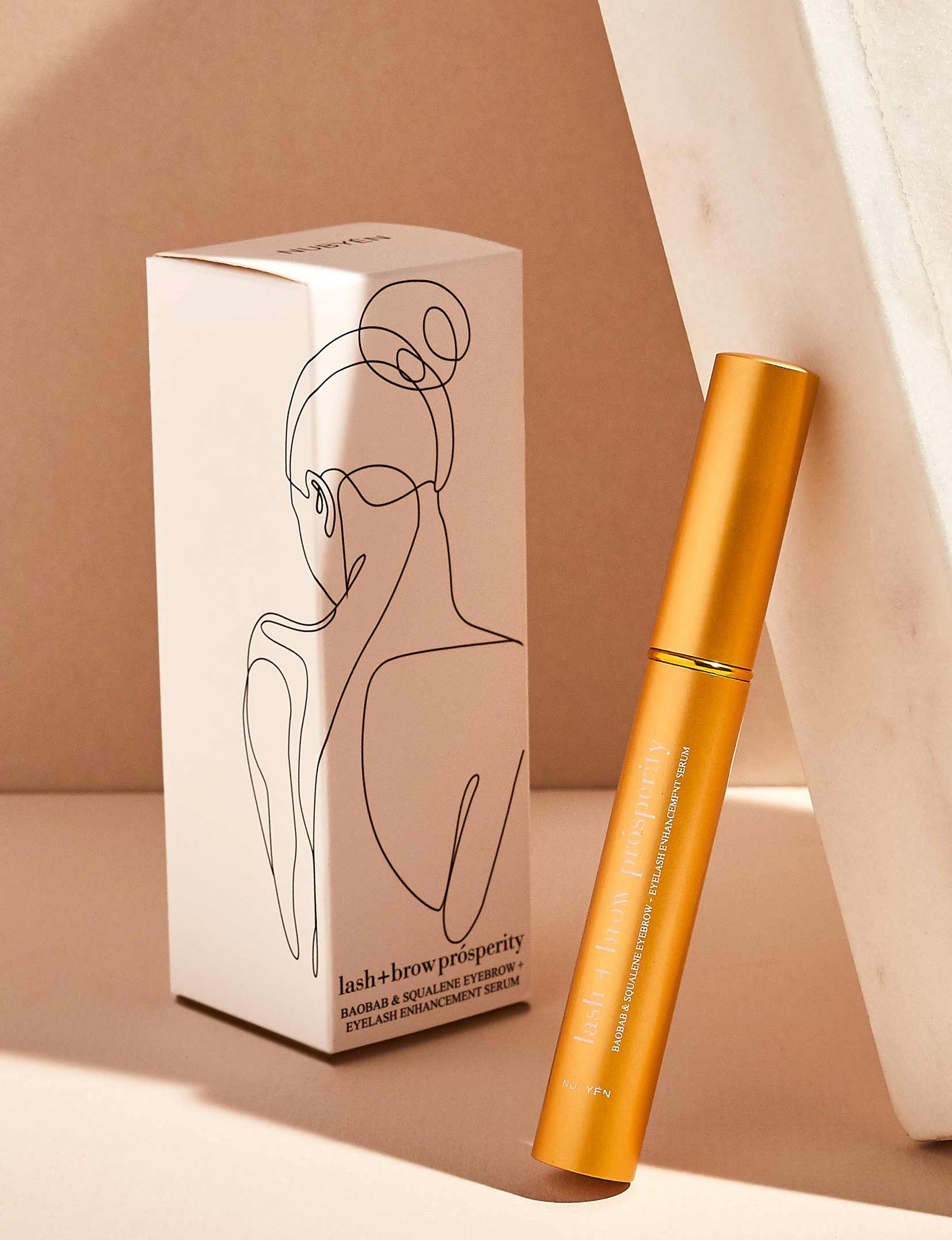 Rejuvenate and strengthen lashes and brows with Nubyén Lash + Brow Prosperity Growth Enhancer. This 100% natural serum combines Baobab, Olive Squalene, Tamanu, and Candlenut oils to repair and nourish hair follicles. Infused with rosemary and raspberry seed extracts, it rebuilds keratin bonds for fuller, thicker brows and lashes. Lightweight, fast-absorbing, and free from harsh chemicals, it's the perfect solution for safe and natural lash and brow enhancement. Pair with Restore Me Brow Pomade for ultimate