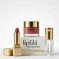 A luxury skincare and lip care set featuring a red lipstick, a gold-lidded jar of lipfilá prosperity cream, a clear bottle of the Minimalist Sunscreen, and their white and gold packaging boxes, arranged on a clean white background.