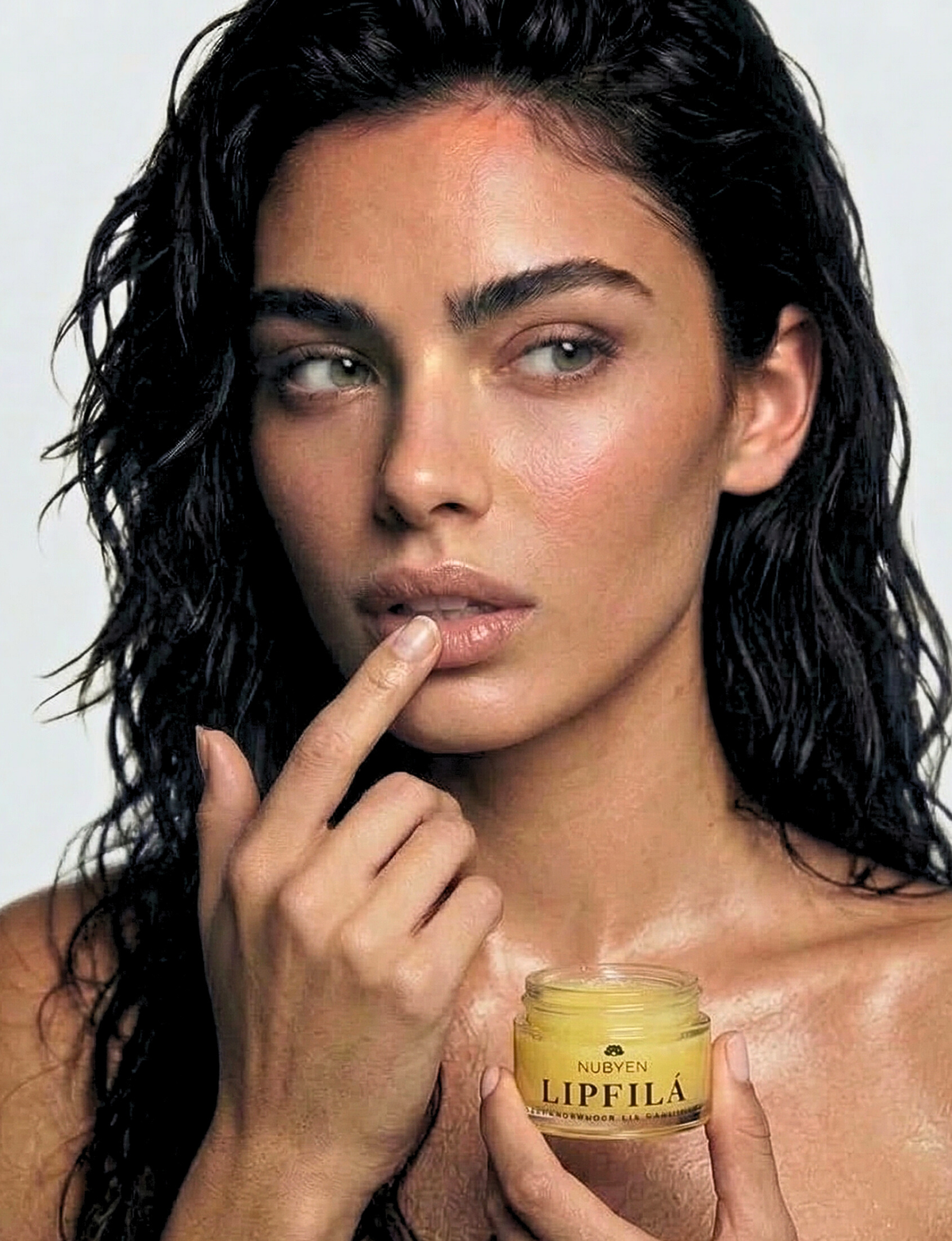 Nubyén Lipfilá lip plumping elixir shown with its white outer box, a gold inner tray, and the open jar placed on top. BEST SELLER