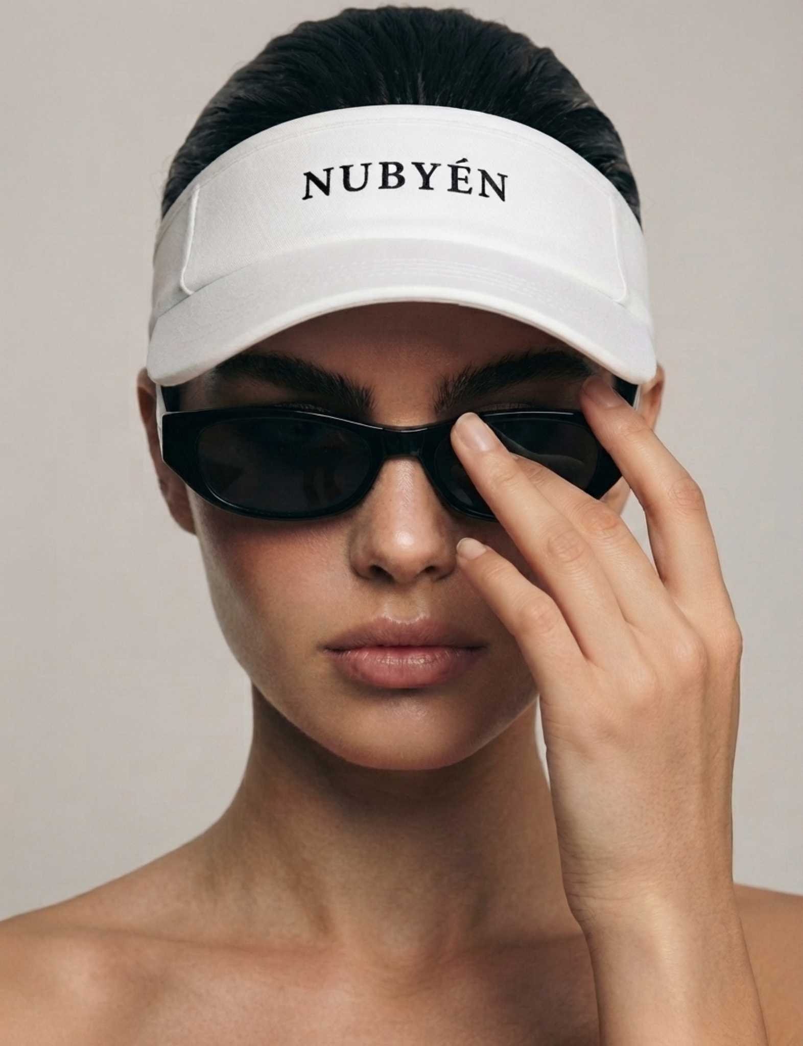 White NUBYÉN premium cotton visor featuring embroidered logo, curved brim and adjustable fit for women's luxury sportswear and everyday wear.
