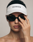 White NUBYÉN premium cotton visor featuring embroidered logo, curved brim and adjustable fit for women's luxury sportswear and everyday wear.