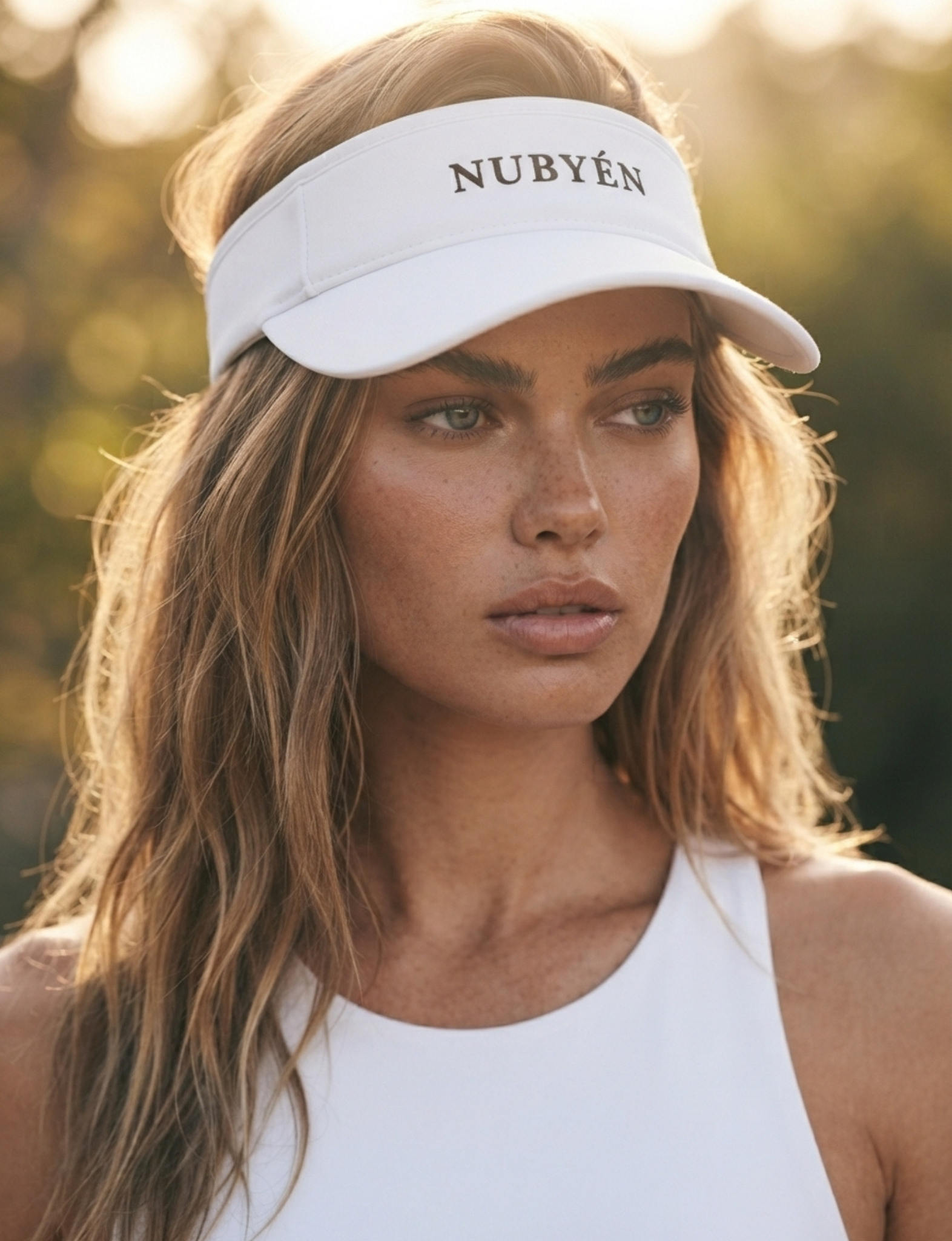 White NUBYÉN premium cotton visor featuring embroidered logo, curved brim and adjustable fit for women's luxury sportswear and everyday wear.