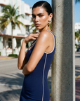 The Nubyen Triumph V-Neck Low Back Mini Dress is a luxury women’s mini dress designed with a sculpting V-neck silhouette, elegant low-back detailing, and refined minimalist tailoring. Crafted for elevated day-to-night styling, the fitted silhouette contours the body while maintaining effortless sophistication. Inspired by contemporary editorial fashion and modern femininity, this sleek black mini dress blends confidence, movement, and timeless elegance with a clean luxury aesthetic perfect for evenings, eve