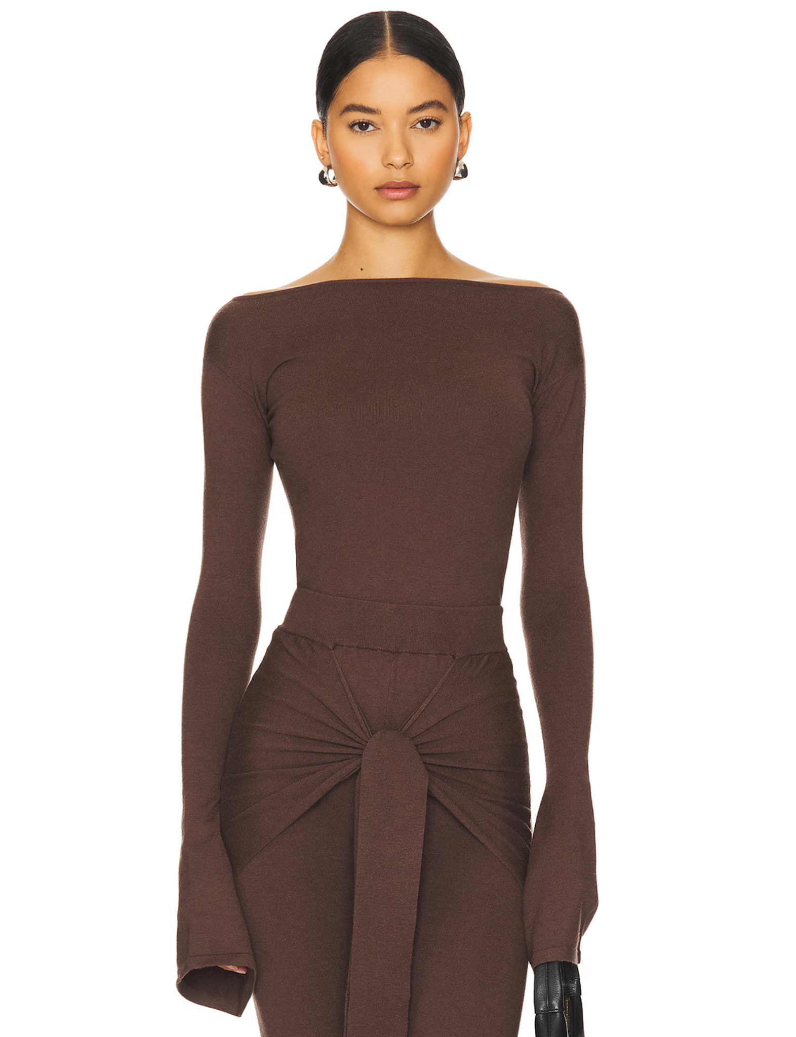 Romy Knit Pants in chocolate brown, featuring a high-waisted fit, soft knit fabric, and a front-tie detail for a stylish and comfortable look. Perfect for casual or elevated cozy outfits

Romy Knit Top styled in a minimalist setting. Featuring a sleek, fitted design with a boat neckline and ribbed texture, it exudes contemporary elegance. Soft lighting and neutral tones enhance its sophisticated appeal.&quot;