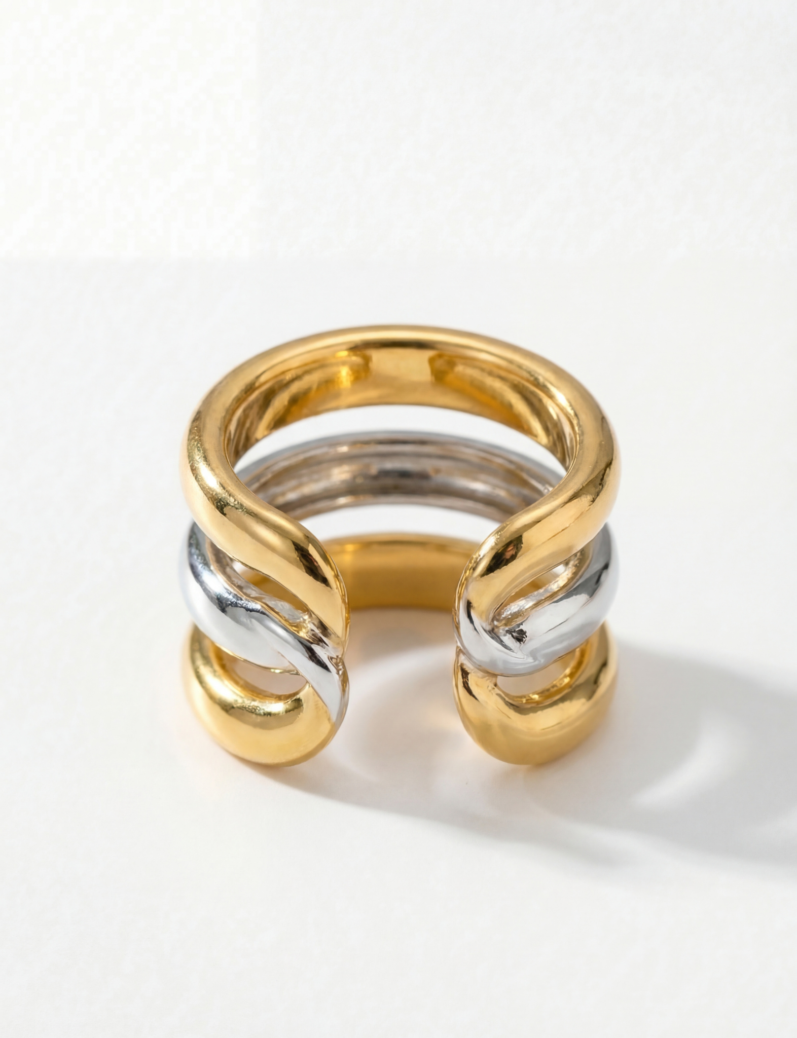 Nubyen Joy two tone chain cuff ring in silver and 18k gold plating with sculptural open cuff silhouette
Luxury two tone statement ring by Nubyen featuring mixed metal gold and silver adjustable cuff design
Sculptural gold and silver cuff ring with fluid open-back silhouette by Nubyen