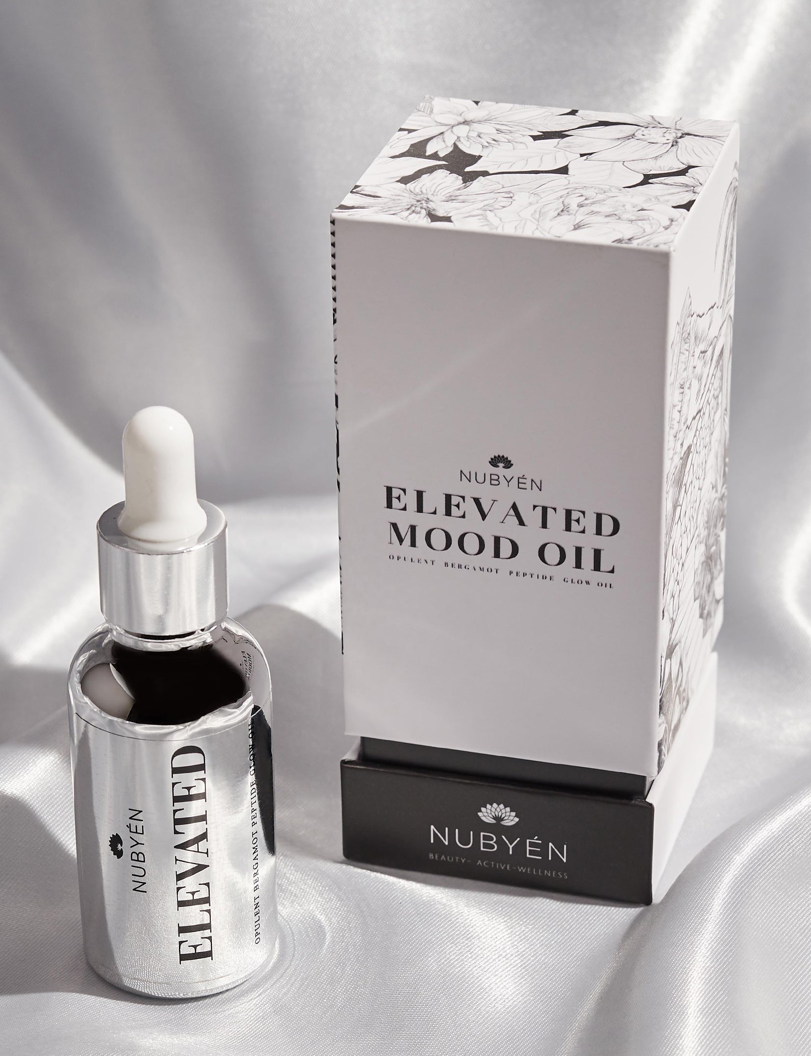 Discover Nubyén Elevated Mood Oil, a hydrating face oil packed with natural ingredients like Camellia Oil, Avocado, Squalene, and Bergamot. This 100% natural, vegan, and cruelty-free formula deeply nourishes, hydrates, and brightens your skin while improving elasticity and reducing wrinkles. Perfect for all skin types, it also enhances your mood with its uplifting scent. Free from sulfates, phthalates, and parabens, this multi-functional oil can also be used for hair, lashes, and brows.