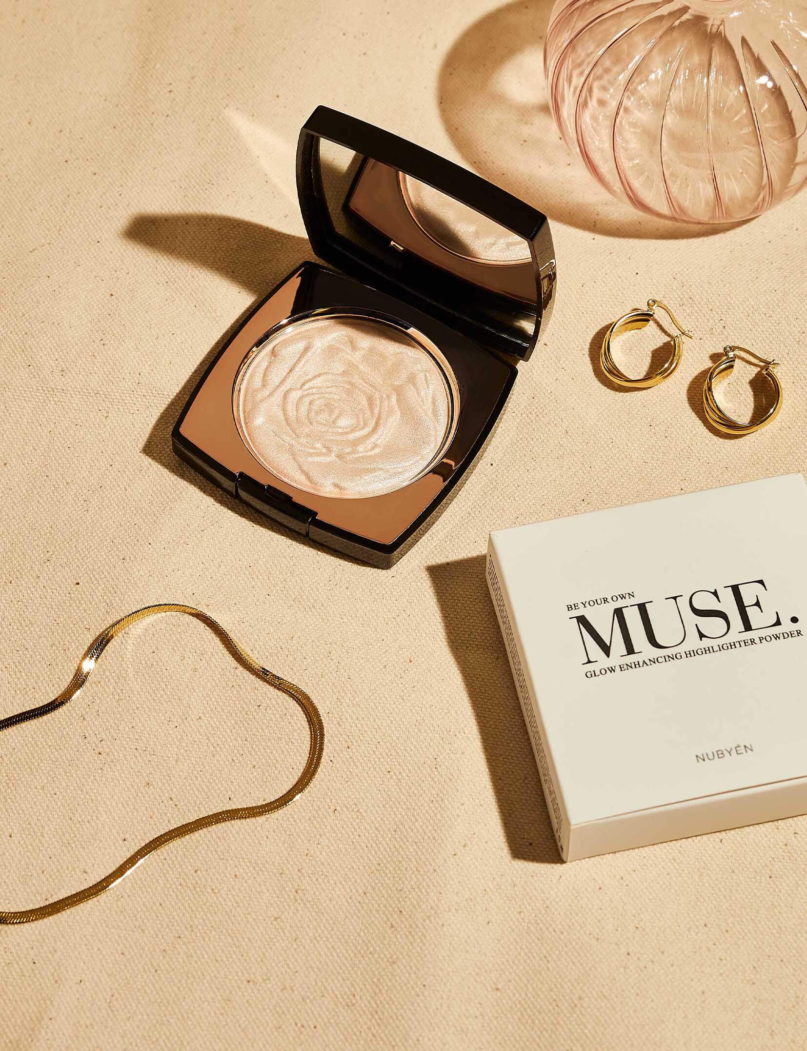 Nubyen Muse Highlighting Powder – vegan, cruelty-free highlighter with handcrafted light-reflecting pearl pigments for a radiant glow. Enhances complexion, blurs fine lines, and adds a subtle shimmer