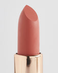 Achieve fuller lips with Nubyén Super Nudes Plumping Lipstick. Vegan, cruelty-free, moisture-matte lipstick infused with peppermint, eucalyptus, lemongrass, and collagen to enhance lip volume naturally. Available in 10 flattering nude shades, perfect for a soft, plump, kissable pout. Safe to use with or without fillers. Clean beauty formula, free of parabens, sulfates, and phthalates.