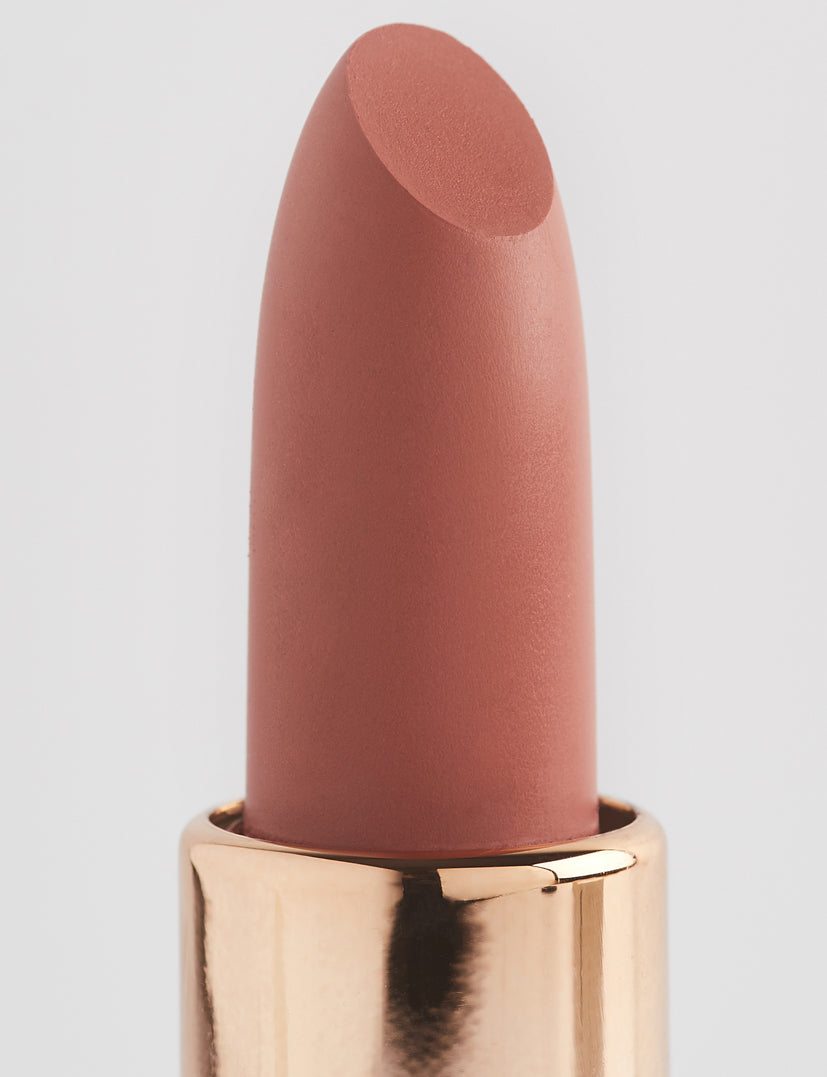 Achieve fuller lips with Nubyén Super Nudes Plumping Lipstick. Vegan, cruelty-free, moisture-matte lipstick infused with peppermint, eucalyptus, lemongrass, and collagen to enhance lip volume naturally. Available in 10 flattering nude shades, perfect for a soft, plump, kissable pout. Safe to use with or without fillers. Clean beauty formula, free of parabens, sulfates, and phthalates.