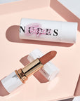 Achieve fuller lips with Nubyén Super Nudes Plumping Lipstick. Vegan, cruelty-free, moisture-matte lipstick infused with peppermint, eucalyptus, lemongrass, and collagen to enhance lip volume naturally. Available in 10 flattering nude shades, perfect for a soft, plump, kissable pout. Safe to use with or without fillers. Clean beauty formula, free of parabens, sulfates, and phthalates.