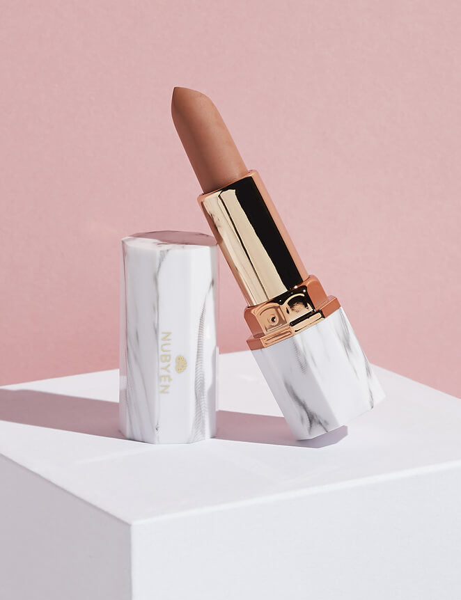 Achieve fuller lips with Nubyén Super Nudes Plumping Lipstick. Vegan, cruelty-free, moisture-matte lipstick infused with peppermint, eucalyptus, lemongrass, and collagen to enhance lip volume naturally. Available in 10 flattering nude shades, perfect for a soft, plump, kissable pout. Safe to use with or without fillers. Clean beauty formula, free of parabens, sulfates, and phthalates.