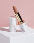 Achieve fuller lips with Nubyén Super Nudes Plumping Lipstick. Vegan, cruelty-free, moisture-matte lipstick infused with peppermint, eucalyptus, lemongrass, and collagen to enhance lip volume naturally. Available in 10 flattering nude shades, perfect for a soft, plump, kissable pout. Safe to use with or without fillers. Clean beauty formula, free of parabens, sulfates, and phthalates.